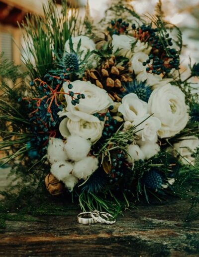 Wedding rings and bridal bouquet beautifully photographed by the wedding photographers in winter
