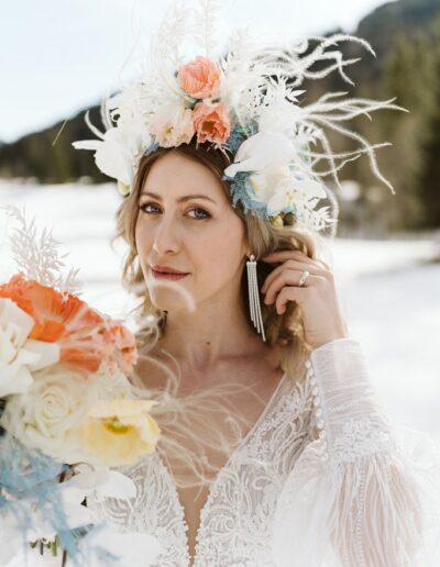Statementohrringe einer Braut auf ihrer winterlichen Hochzeit in den Bergen im Allgäu