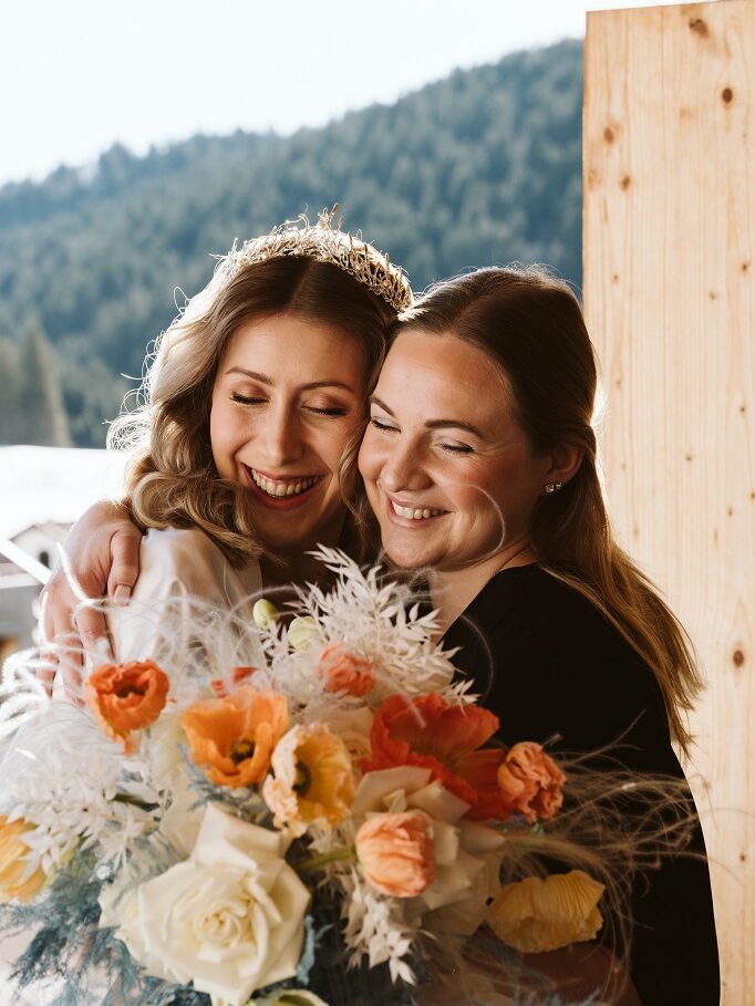 Wedding Day Coordinator handing over the bridal bouquet to a relaxed bride