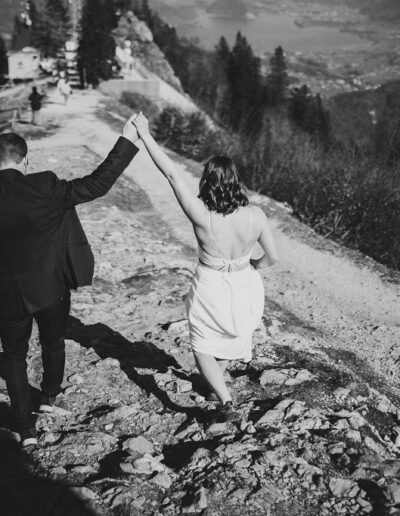 Brautpaar nach der freien Trauung auf dem Gipfel auf dem Weg nach unten zur Hochzeitslocation in den Bergen