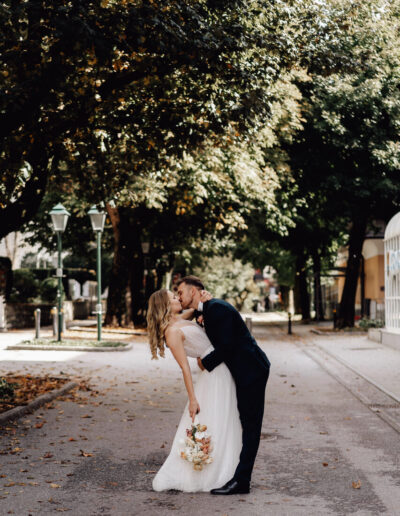 Kissing bride and groom at their mountain wedding in Austria