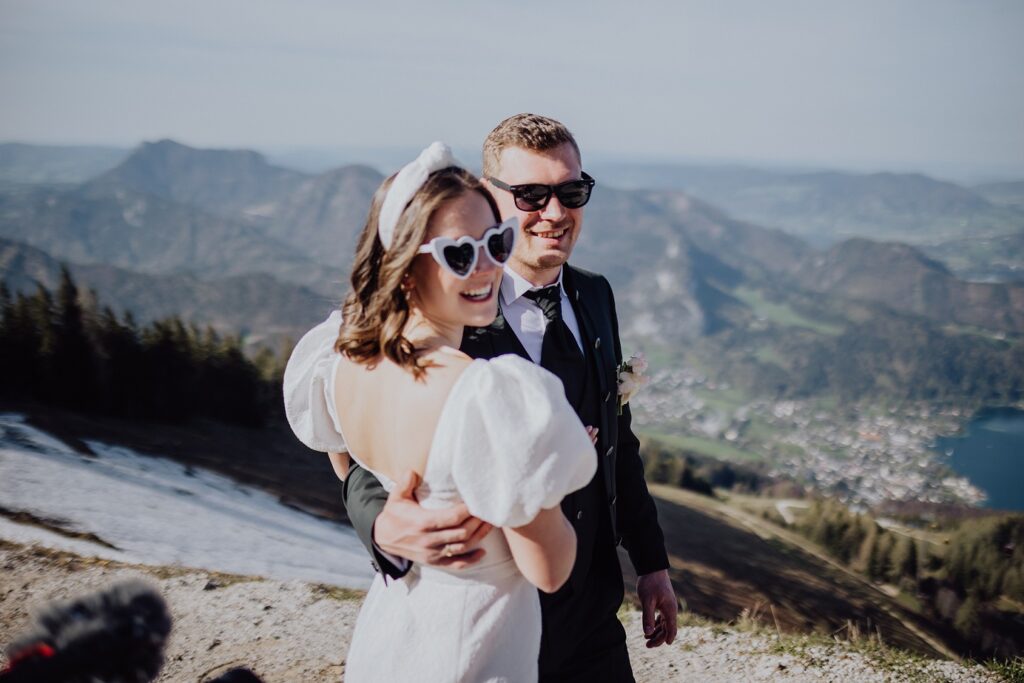 Bride and groom with sunglasses in the mountains in spring