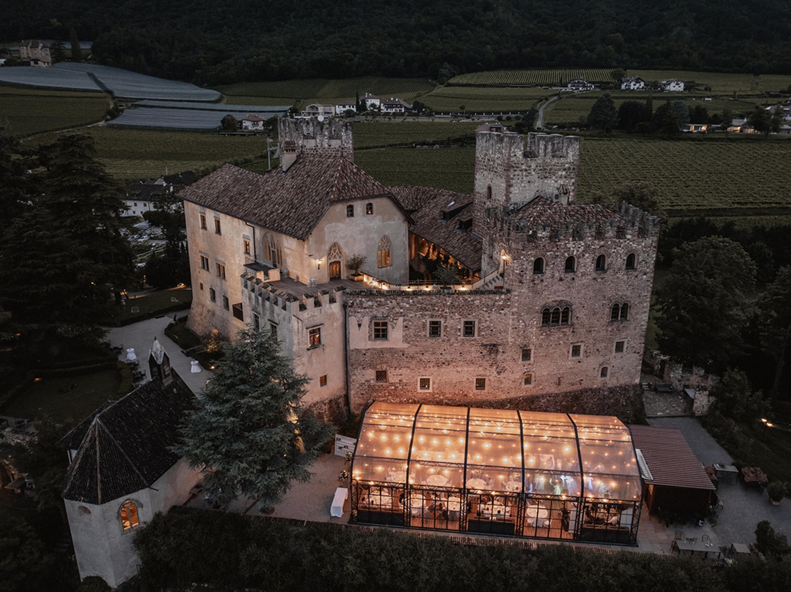 Luftaufnahme von Schloss Freudenstein bei Bozen – traumhafte Hochzeitslocation in Südtirol für exklusive Berghochzeiten mit Blick auf Weinberge und Alpen.